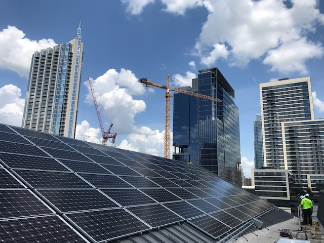 Solar panels with Austin high rise buildings in background.